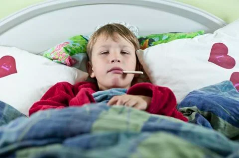 Boy in bed with the flu Stock Photos