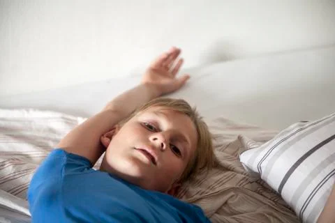 Boy on a bed Stock Photos