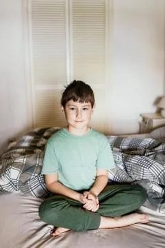 Boy on a bed Stock Photos