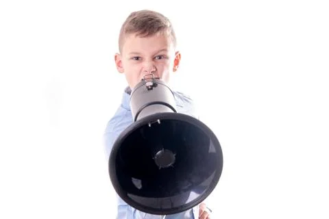 Boy behind a black megaphone roars a text Foto stock