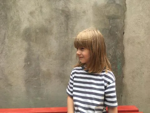 Boy on the bench outside Stock Photos