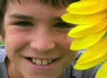 Boy Beside Sunflower SD Footage