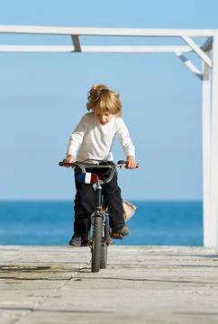 Boy on bicycle Stock Photos