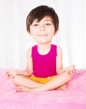 Boy with big head sitting in bed and smiling Stock Photos