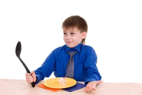 Boy with a big spoon Stock Photos