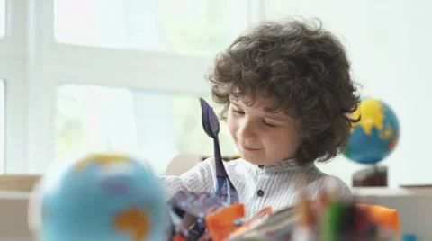Boy with black curly hair look book with pictures Stock Footage