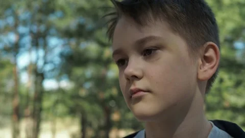 The boy with the black eye turns to the camera and walks away Stock Footage 154125779