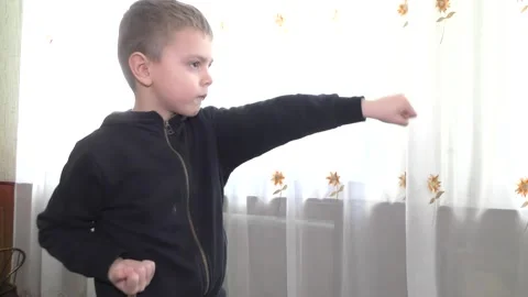 The boy in the black jacket beats punches Stock Footage 136432228