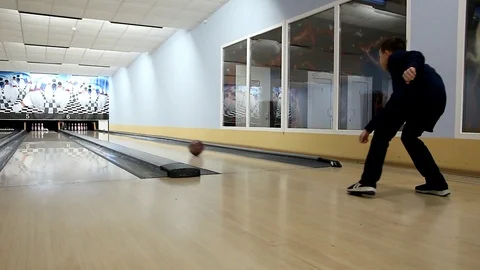 Boy in a black tracksuit throws the ball on the track bowling Stock Footage 111548551