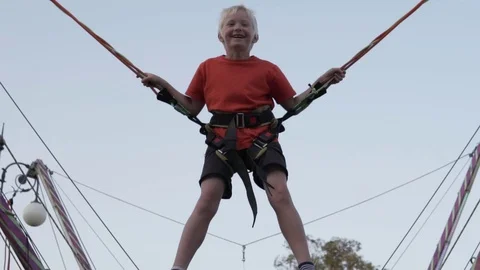 Boy blond jumps on trampoline Stock Footage 108710989