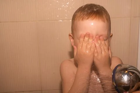 Boy blond in the shower Stock Photos