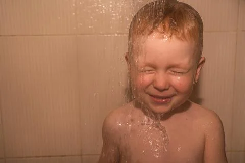 Boy blond in the shower Stock Photos