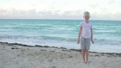 Boy blonde makes hands heart on head Stock Footage 122309116