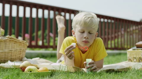 Boy is blowing bubbles Stock Footage 66060408