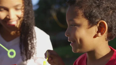 A Boy Blowing Bubbles with His Mom | Stock Video | Pond5