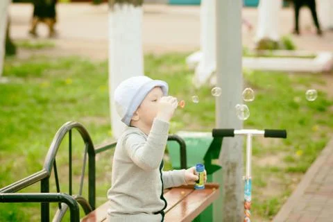 Boy blowing bubbles Stock Photos