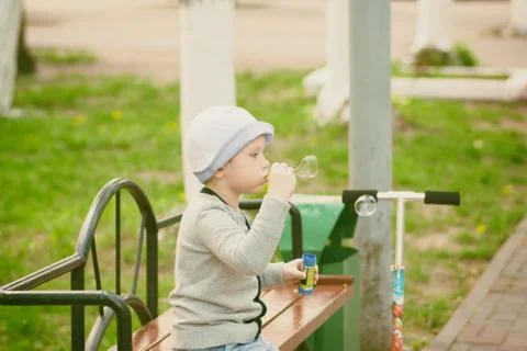 Boy blowing bubbles Stock Photos