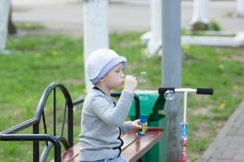 Boy blowing bubbles Stock Photos