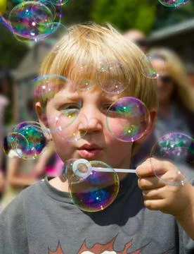 Boy Blowing Bubbles Stock Photos