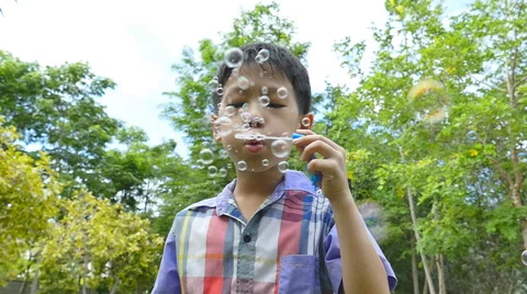 Boy blowing bubbles, slow motion Stock Footage 52850771