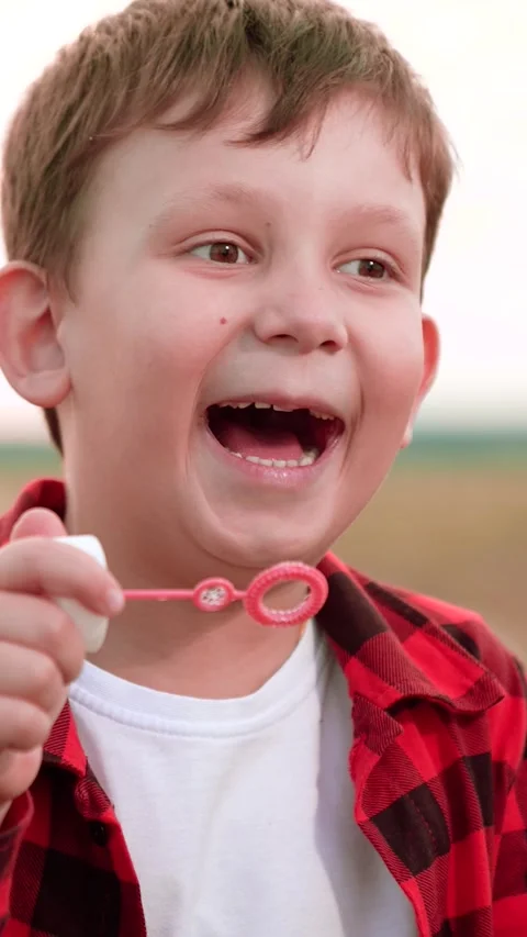 Boy blowing soap bubbles, happy child kid, open space fun, personal play moment Stock Footage 295252591