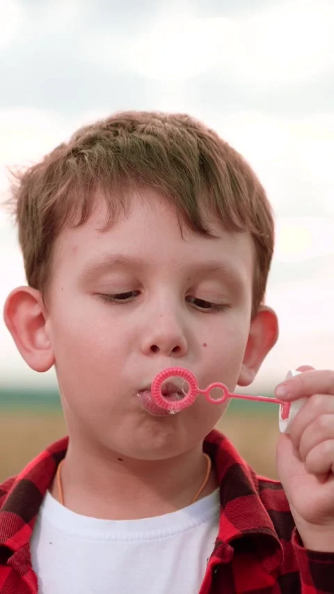 Boy blowing soap bubbles, happy child kid, nature background play, outdoor Stock Footage 295807664