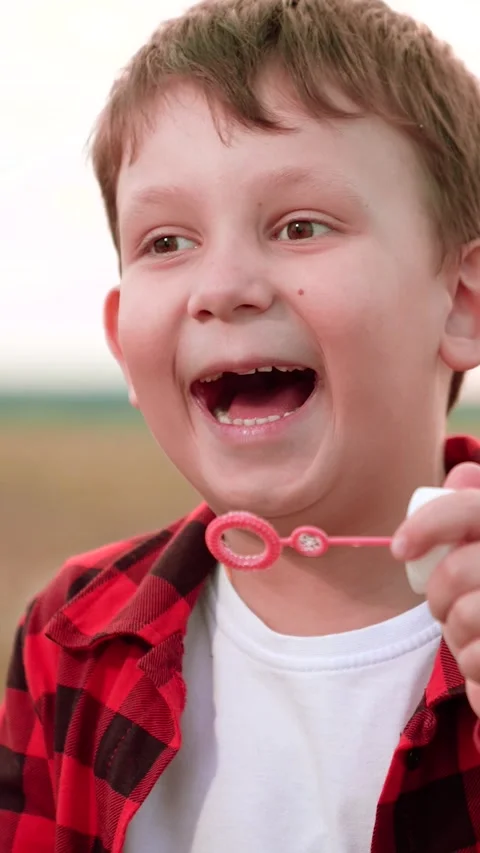 Boy blowing soap bubbles, happy child kid, simple joys childhood, boy outdoor Stock Footage 296707742