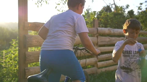 Boy Blowing Soap Bubbles At Sunset, Slow motion Stock Footage 67808390