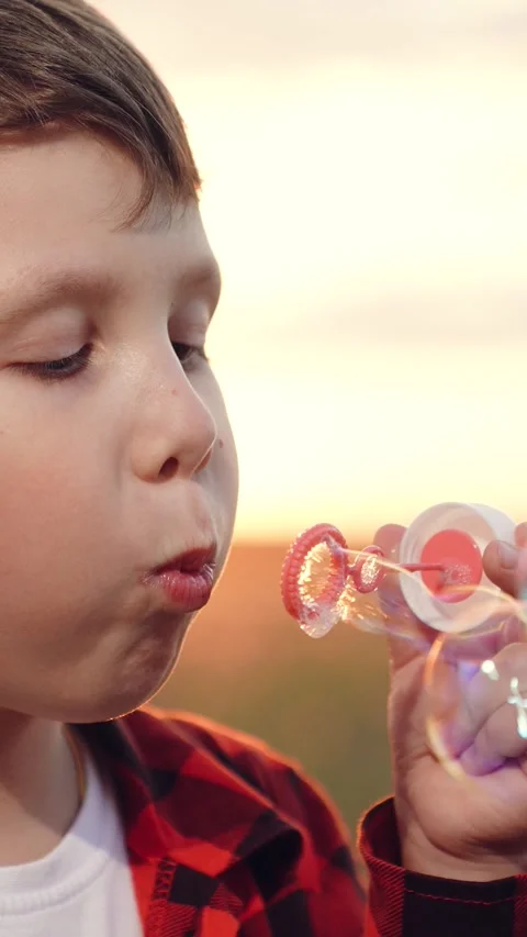 Boy blowing soap bubbles sunset, happy child kid, pure childhood joy, happy Stock Footage 303074584