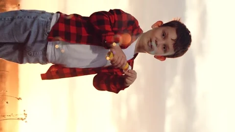 Boy blowing soap bubbles sunset, happy child kid, pure childhood joy, happy Stock Footage 304625488