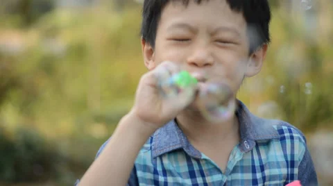 Boy blows soap bubbles Stock Footage 37695333