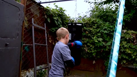 Boy in blue boxing gloves Stockbeeldmateriaal 207769746