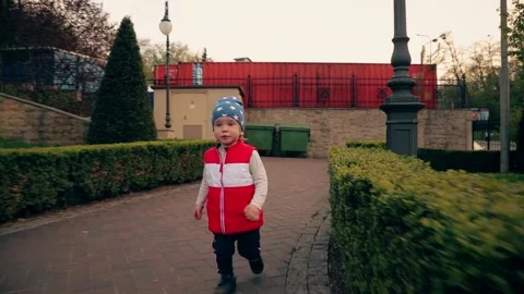 A boy in a blue cap runs  to meet mom Stock Footage 153559965