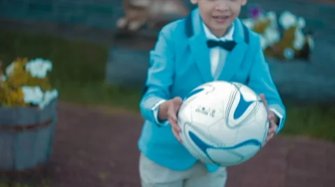 Boy in Blue Jacket Plays With the Ball Stock Footage 68791680