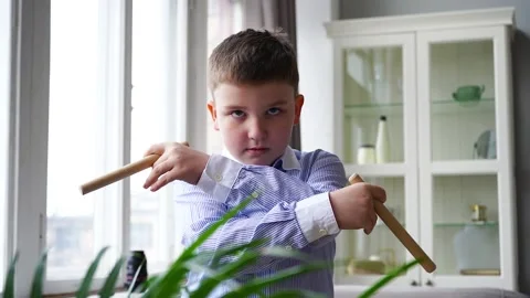 A boy in a blue shirt is studying techniques with chucks. Stock-Footage 160854193