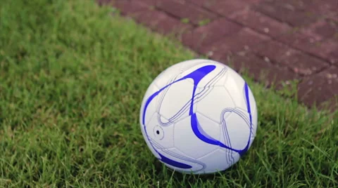 Boy in Blue Suit Picks up Ball Lying on Grass Near House Slow Motion Stock Footage 64524119