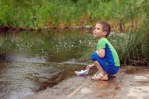 Boy with a boat. Stock Photos