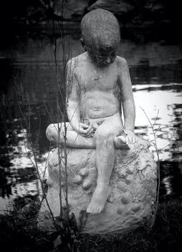 Boy with boat statue Stock Photos