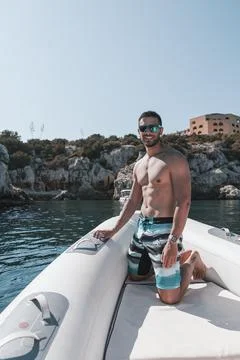 Boy on a boat sunbathing Stock Photos