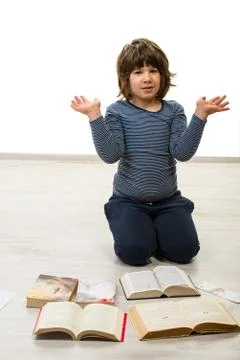 Boy with books gesticulate Foto stock