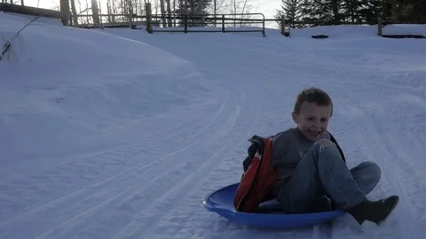 Boy at bottom of sledding hill Stock Footage 72254427