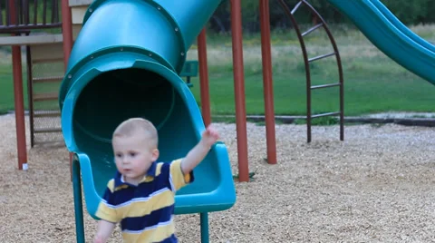Boy at the bottom of a slide.  Video stock 27888407