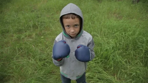 Boy in boxing gloves Stock Footage 64386911