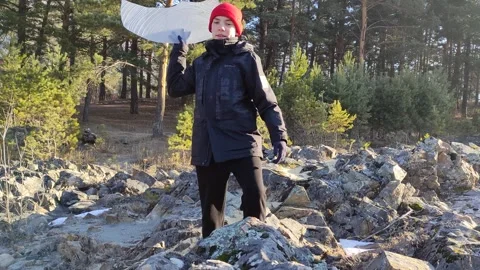 Boy breaks ice on a sunny winter day. Stock Footage 304979698