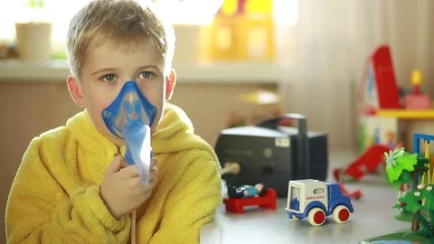  the boy is breathing through a nebulizer mask Stock Footage 69820949