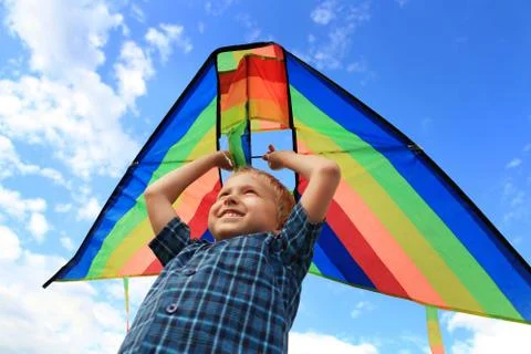 Boy with bright kite over the head Foto stock