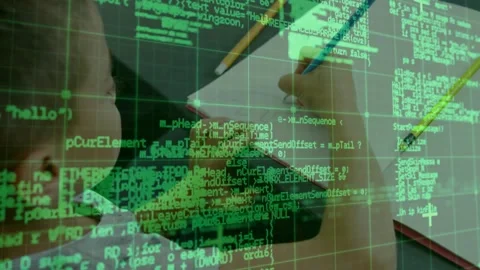 Boy bringing pencil close to notebook in study practicing code concepts as green Stock Footage 320089012