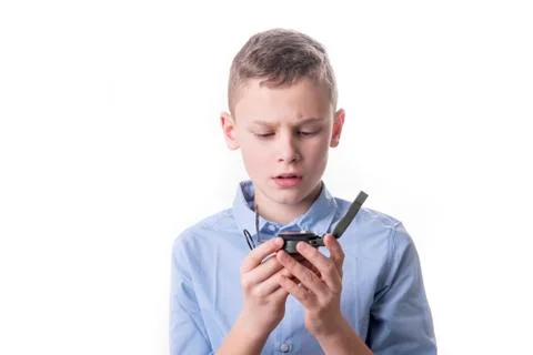 Boy brooding over his future sitting with a compass in his hand and isolated Stock Photos