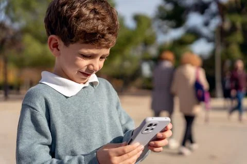 Boy browsing cellphone in park Stock Photos