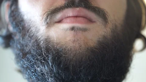 A boy brushes his beard Stock Footage 95432873